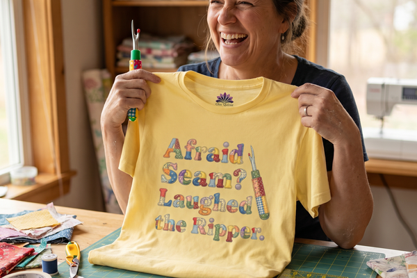 A laughing quilter holding a seam ripper and the Afraid Seam? Laughed the Ripper premium tee