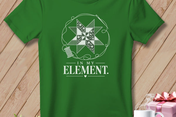 Green t-shirt with a quilt block design and "In My Element" text.