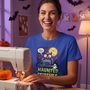 A quilter sewing in her Halloween-decorated sewing room, wearing the Haunted Stitches tee