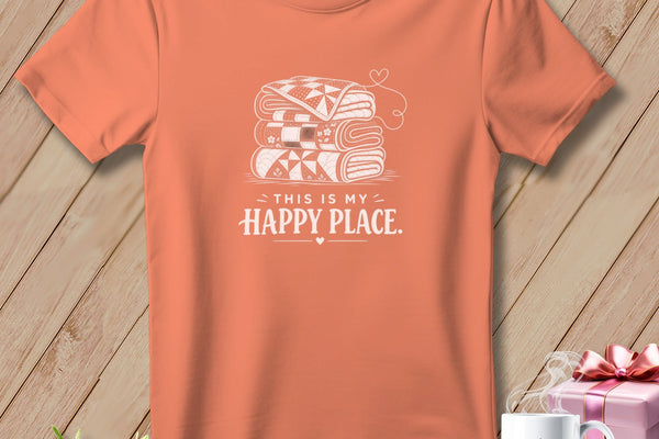 Orange t-shirt with stacked quilts graphic and "This is my happy place" text.