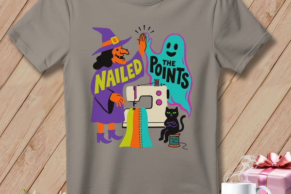 Witch and ghost high-five over sewing machine with text "Nailed The Points."