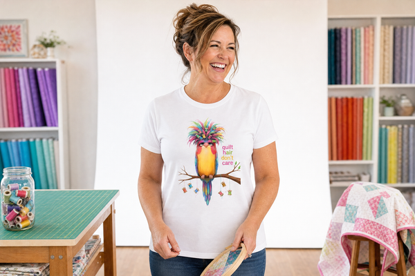 A quilter smiling in her sewing room, wearing the Quilt Hair Don't Care tee