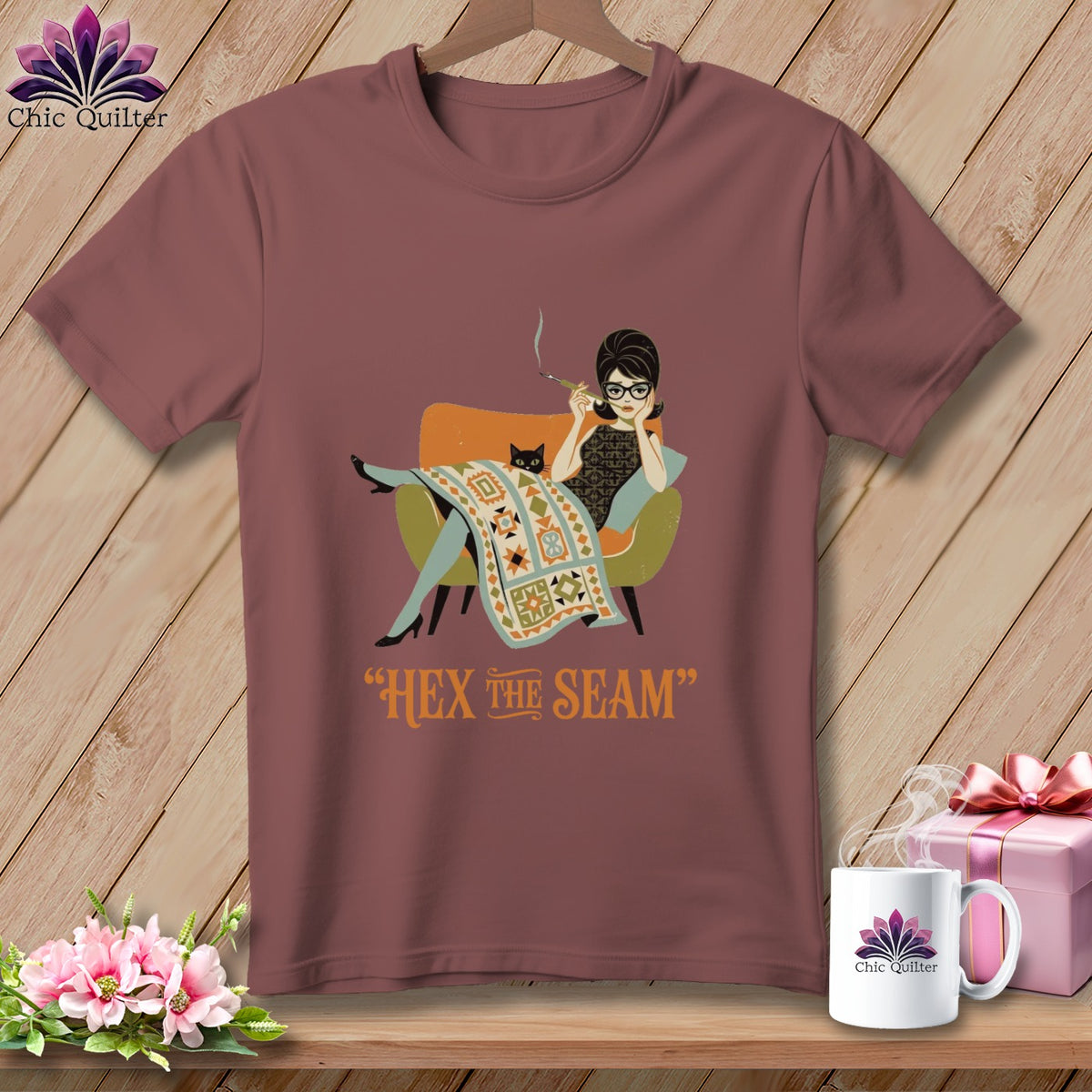 T-shirt graphic of Audrey Hepburn-like woman with cat and quilt, "Hex the Seam".