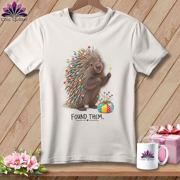 White t-shirt with a porcupine stuck with pins and the text "FOUND THEM."