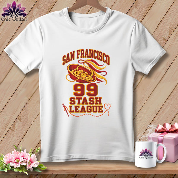 A white t-shirt on a wooden background features a San Francisco 99 Stash League graphic.