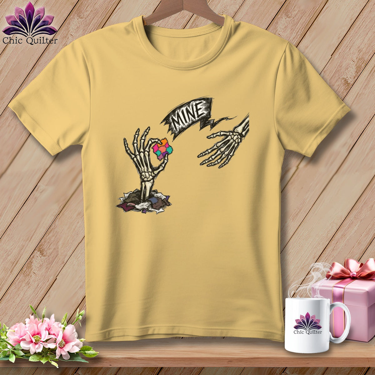 Yellow t-shirt with skeleton hands reaching for a puzzle piece, text "MINE".
