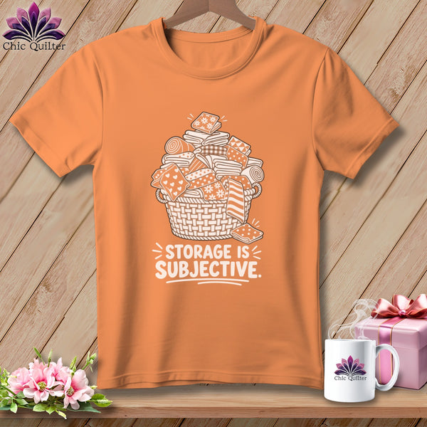Orange t-shirt with basket of fabric and "STORAGE IS SUBJECTIVE" text.