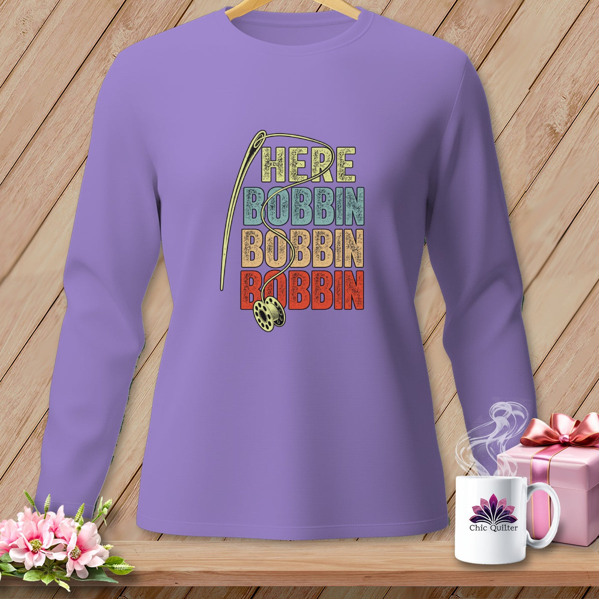 Purple long-sleeve shirt with needle, bobbin, and "Here Bobbin Bobbin Bobbin" text.