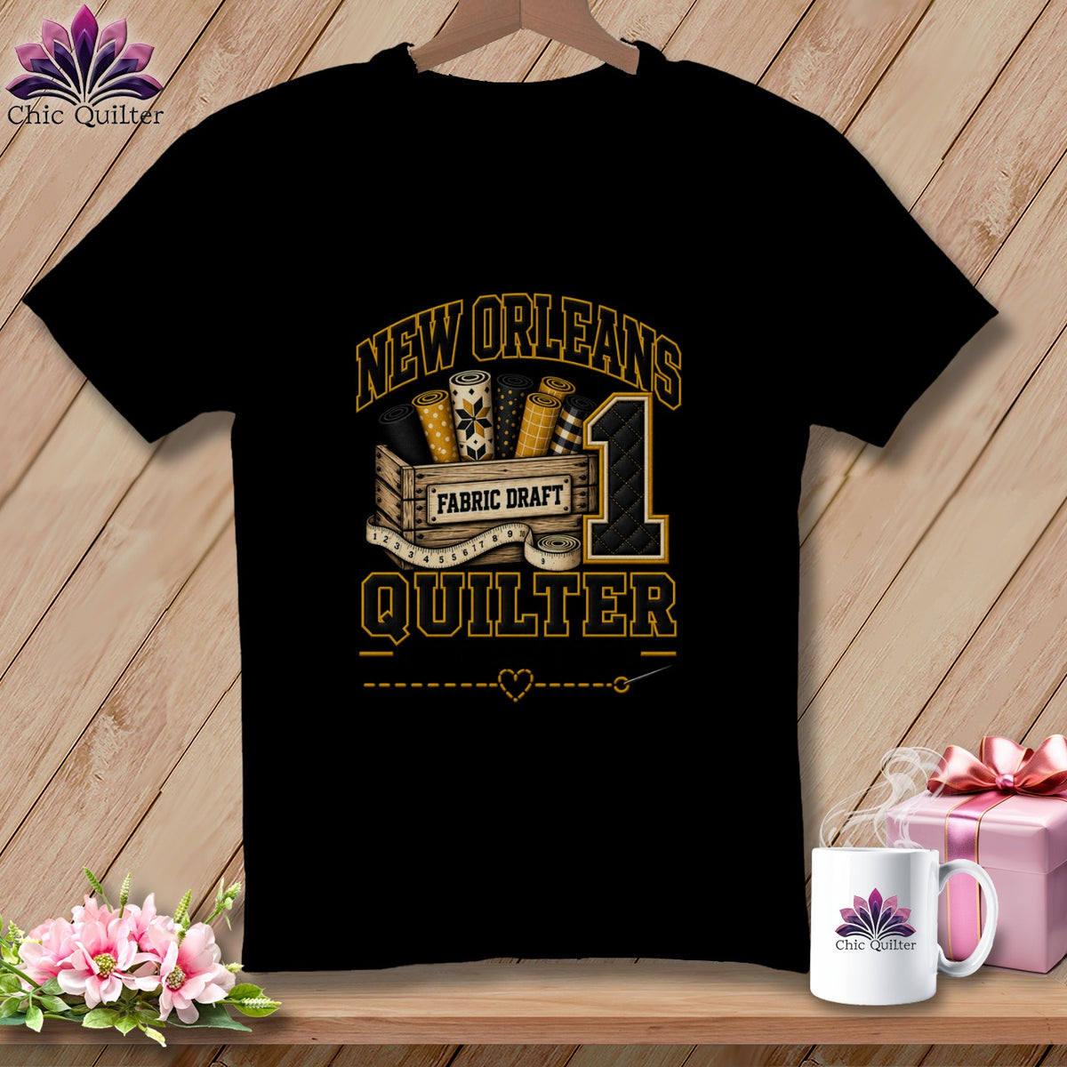 A black t-shirt hanging on a wooden wall displays graphic text reading New Orleans Quilter alongside a crate of fabric rolls and a large number one.