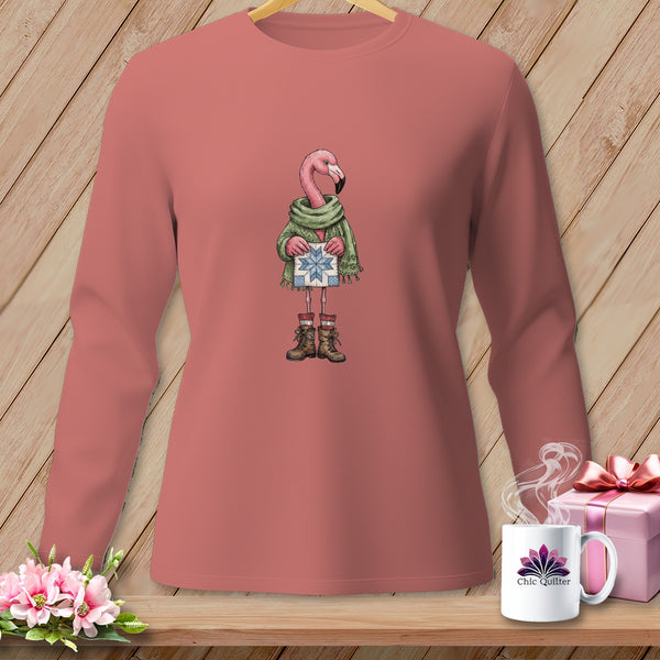 Pink flamingo wearing a scarf and boots holding a snowflake gift box.