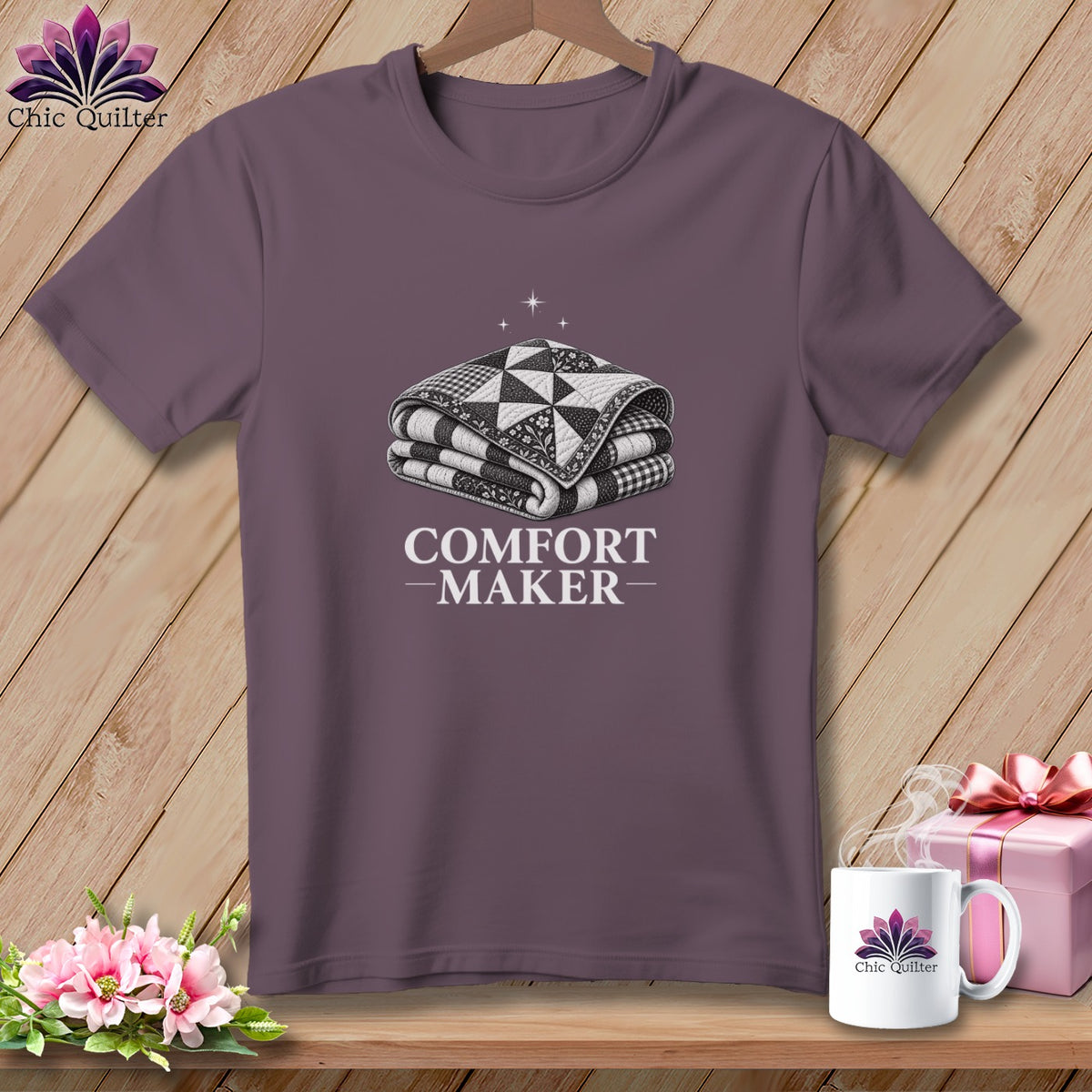 Purple t-shirt with graphic of folded quilt and text "COMFORT MAKER".