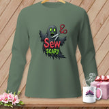 Green long-sleeve shirt with ghost and scissors graphic reading 