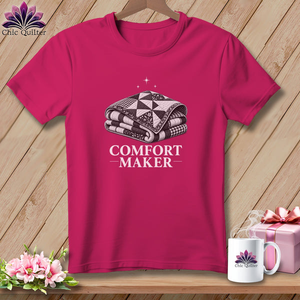 Pink t-shirt with a folded quilt graphic and "COMFORT MAKER" text.