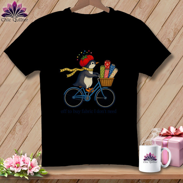 Penguin on a bicycle with fabric rolls and "off to buy fabric I don't need" text.