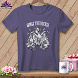 A purple t-shirt with a graphic of a startled duck under a torn quilt with the text 