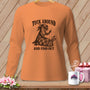 An orange long-sleeve shirt displays a graphic of an otter sewing a quilt wrapped around a sweating rabbit, with the text TUCK AROUND AND FIND OUT.