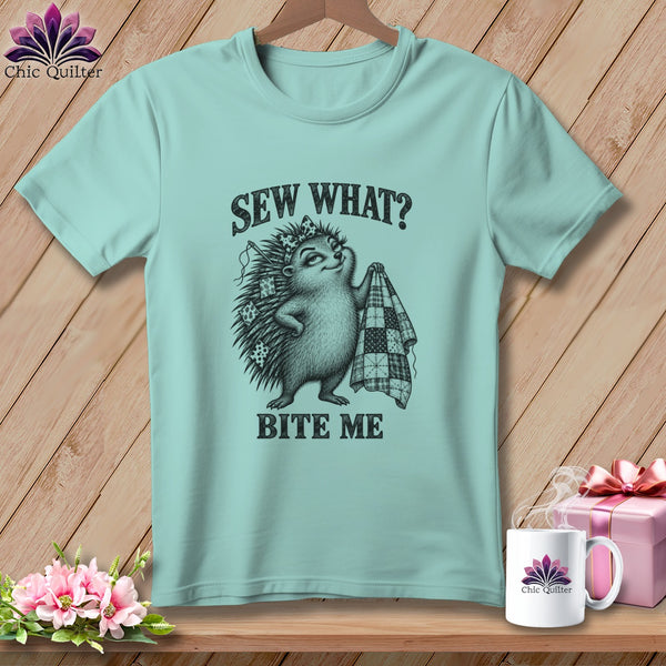 A light teal t-shirt featuring a hedgehog holding a quilt with text that reads Sew What Bite Me.