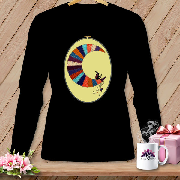 Black long-sleeve shirt with a crescent moon applique featuring a witch riding a broomstick.