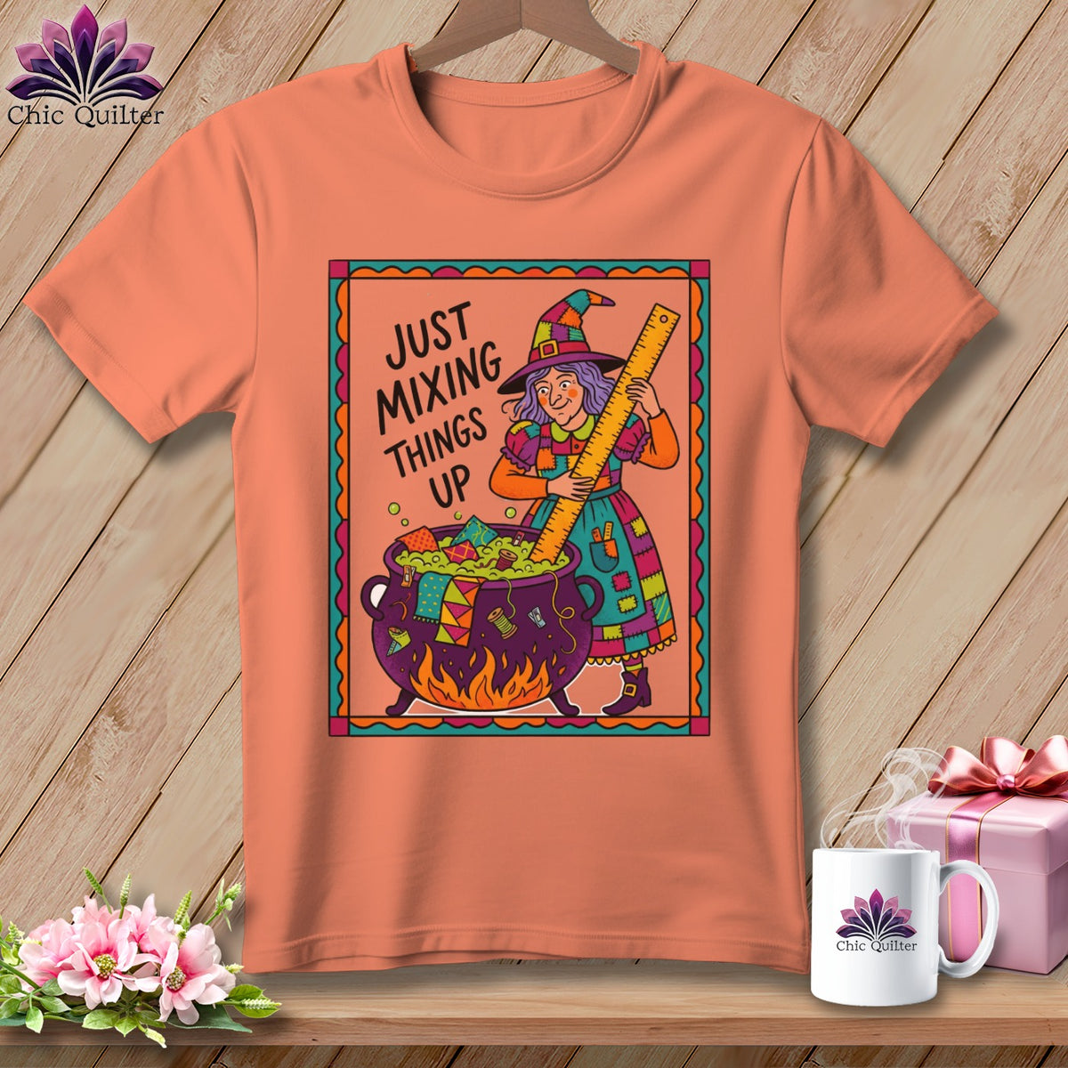 Peach t-shirt with a witch stirring a cauldron with the text "Just Mixing Things Up".