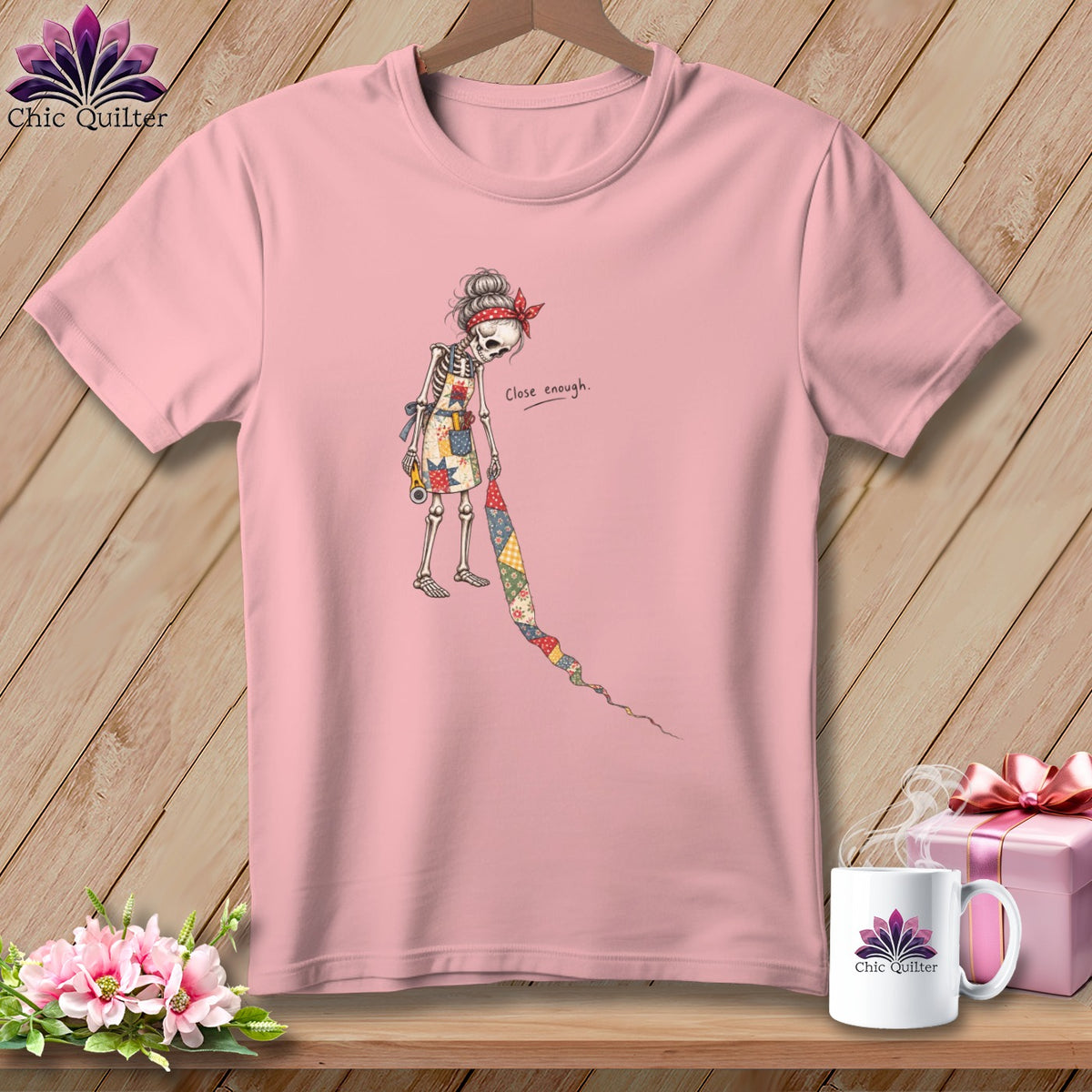 Pink t-shirt with skeleton graphic holding quilt scraps, text "Close enough."
