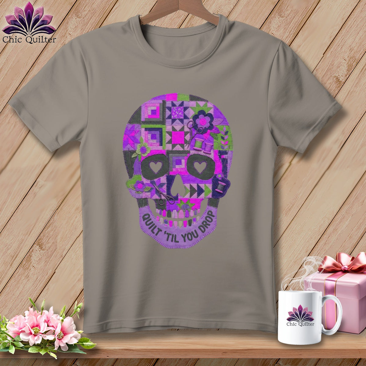 Gray t-shirt with a colorful quilted skull design and text "Quilt 'til You Drop".