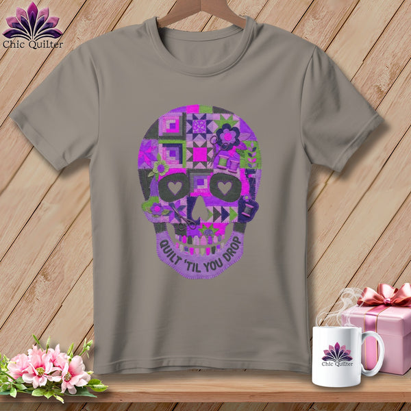 Gray t-shirt with a colorful quilted skull design and text "Quilt 'til You Drop".