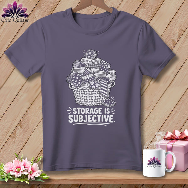 Gray t-shirt with a white graphic of a basket overflowing with fabric and the text "STORAGE IS SUBJECTIVE."