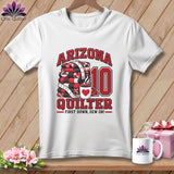 A white t-shirt features graphic text reading Arizona Quilter, a stack of quilts, and a coffee mug.