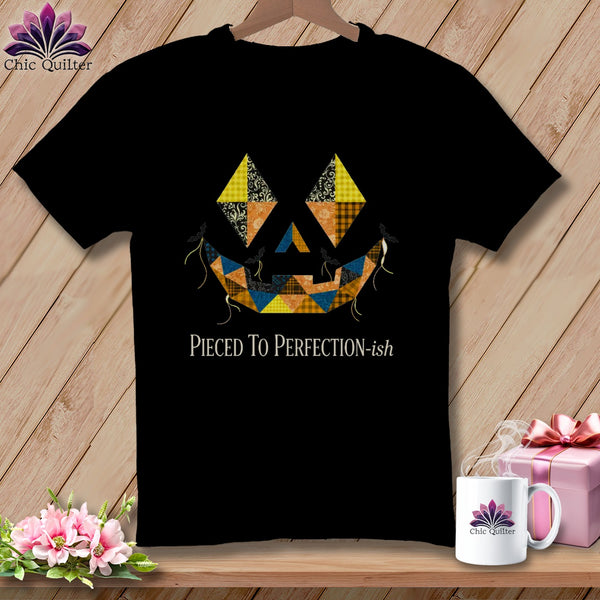 Black t-shirt with a patchwork jack-o-lantern face and "Pieced To Perfection-ish" text.