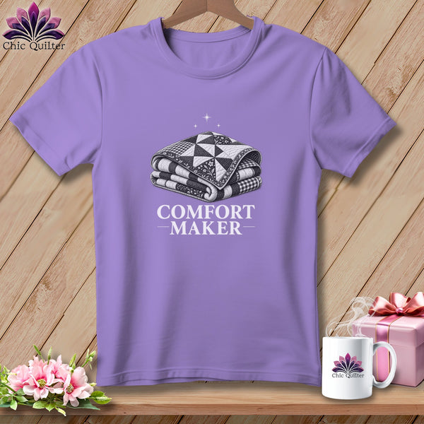 Lavender t-shirt with graphic of folded quilt and text "COMFORT MAKER".