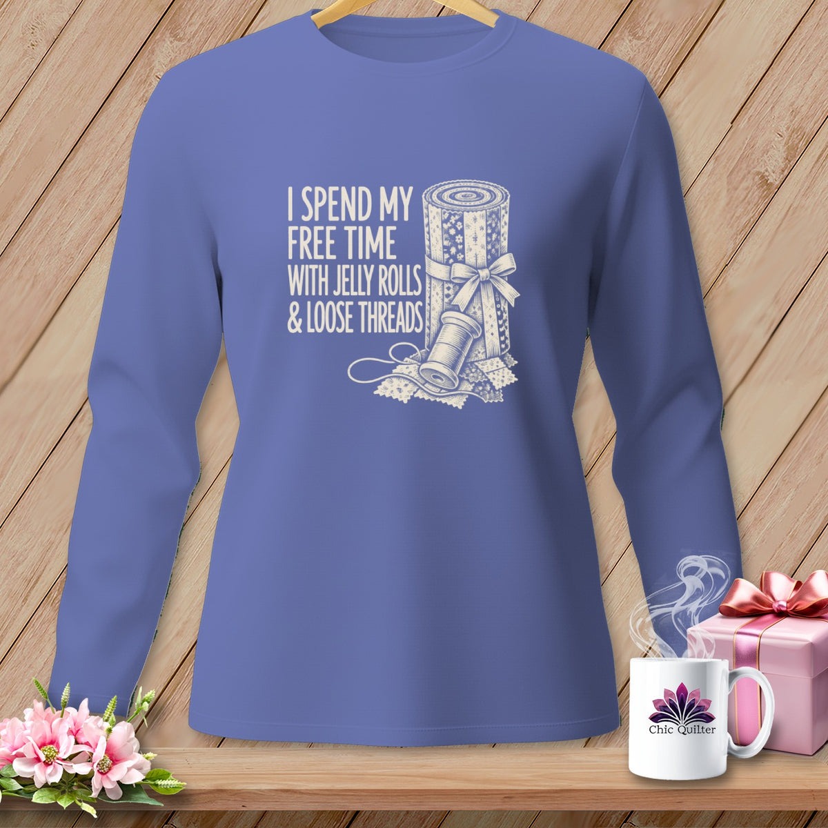 Blue long-sleeve shirt with "I spend my free time with jelly rolls & loose threads" text and quilting graphic.
