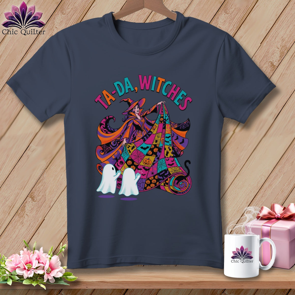 Dark t-shirt with "TA-DA, WITCHES" and a witch with ghosts and Halloween patterns.