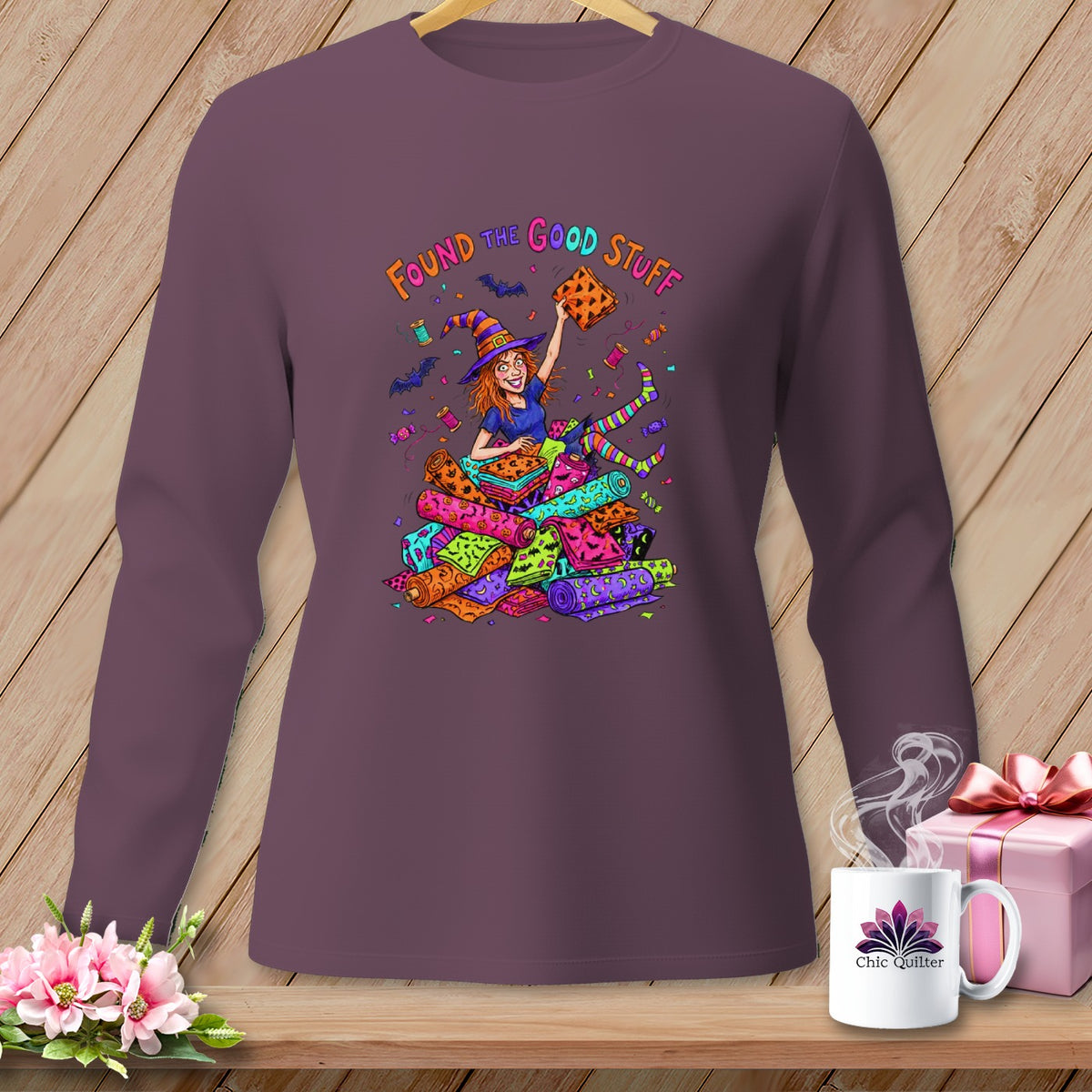 Witch holding fabric rolls with "Found the Good Stuff" text.
