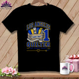 Black t-shirt featuring Los Angeles Quilter graphic with fabric rolls in a wooden crate and number one.