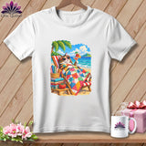 White t-shirt featuring a colorful graphic of a cat relaxing in a beach chair with a cocktail and quilt.