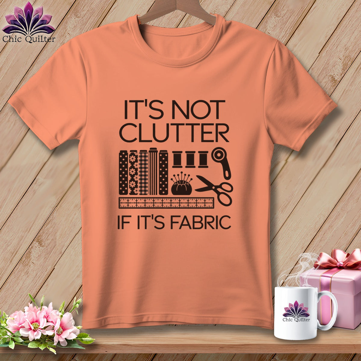 Peach t-shirt with "It's not clutter if it's fabric" sewing graphic.