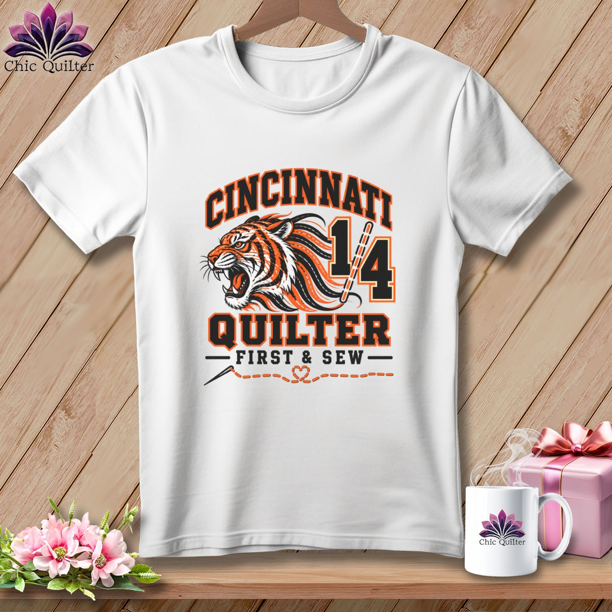 A white crewneck t-shirt featuring a Cincinnati Quilter design with a roaring tiger illustration and text.