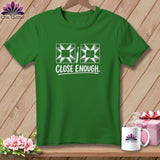 Green t-shirt with white quilting blocks, a seam ripper, and 