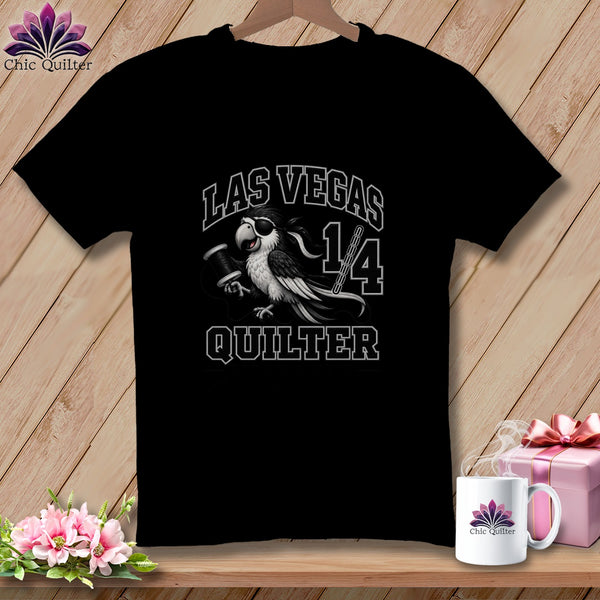 A black t-shirt featuring a parrot with an eye patch holding a spool of thread, surrounded by the text Las Vegas Quilter.