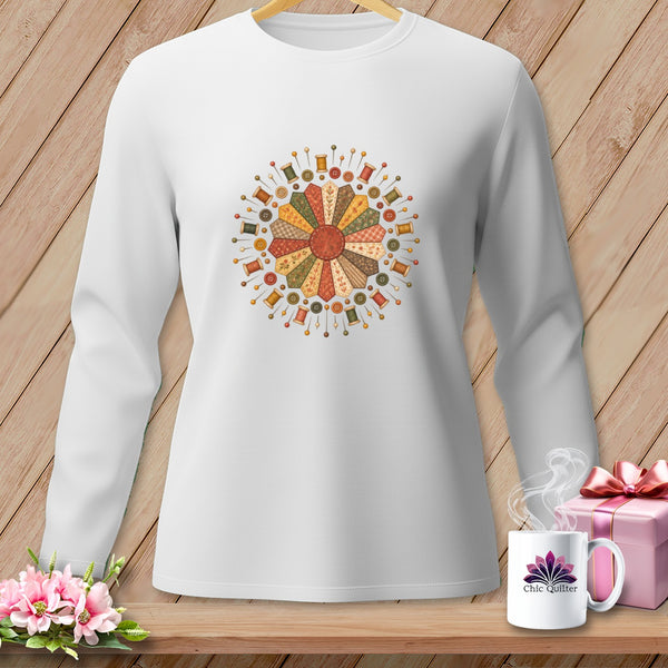 White long-sleeved shirt with a circular quilt-themed print featuring spools and buttons.