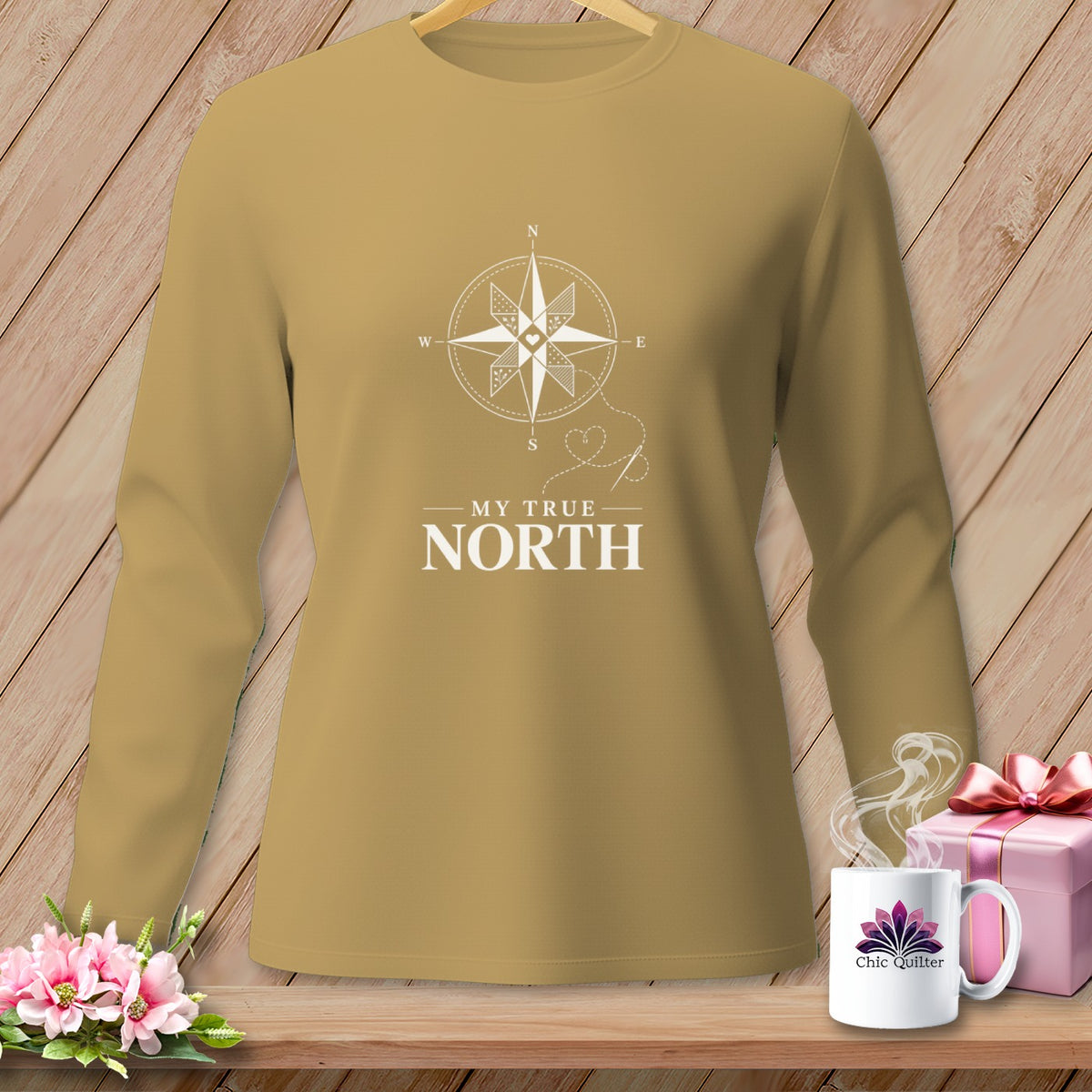 Long-sleeved tan shirt with white compass design and text "MY TRUE NORTH".
