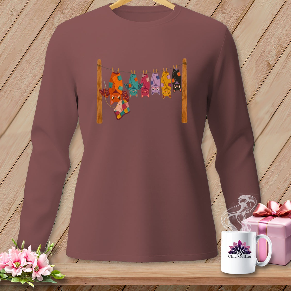 Long-sleeve shirt with a graphic of colorful bats hanging from a clothesline.