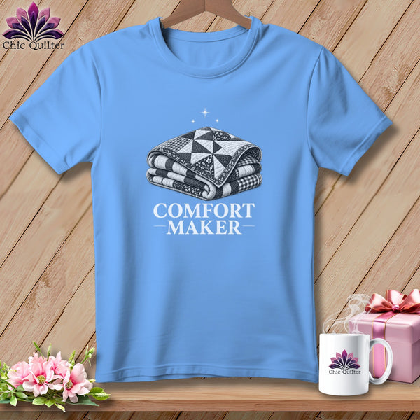 Light blue t-shirt with a folded quilt and "COMFORT MAKER" text.