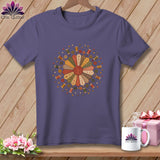 Purple t-shirt with a circular quilting design featuring spools of thread and buttons.
