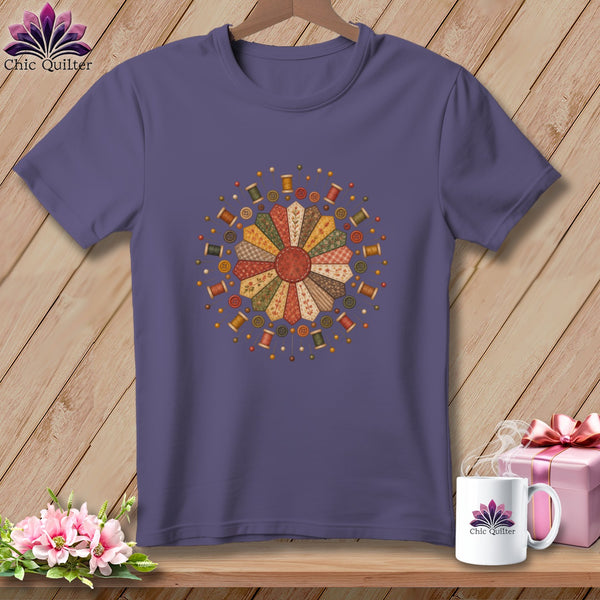 Purple t-shirt with a circular quilting design featuring spools of thread and buttons.