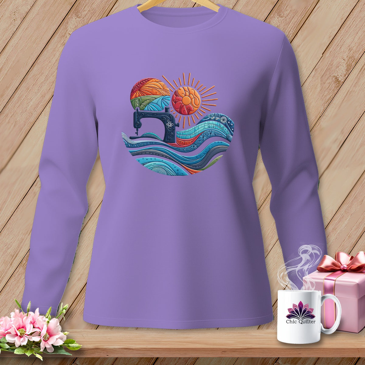 Purple long-sleeve shirt with sewing machine, yarn, sun, and wave graphic.