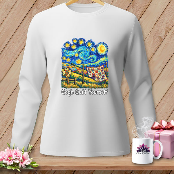 White long-sleeve shirt with a "Gogh Quilt Yourself" graphic depicting a quilt hanging outdoors under a starry sky.
