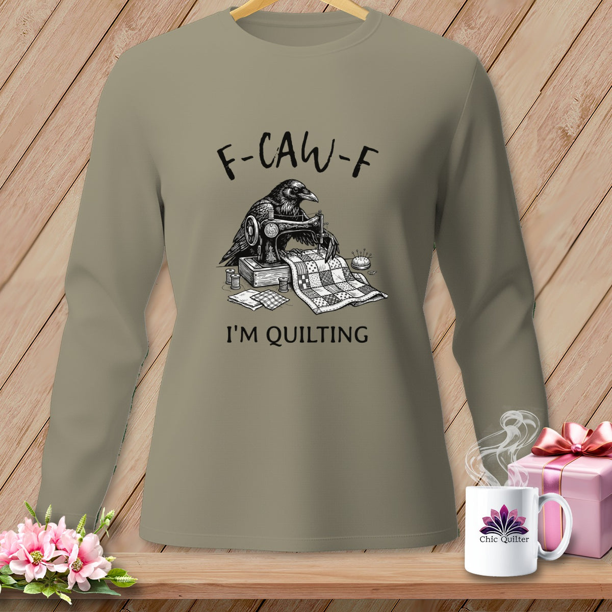 Long-sleeve shirt with a raven sewing a quilt, "F-CAW-F I'M QUILTING" text.