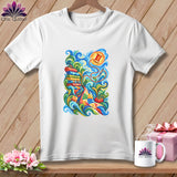 White crewneck t-shirt featuring a colorful, swirling quilting illustration on a wooden background.