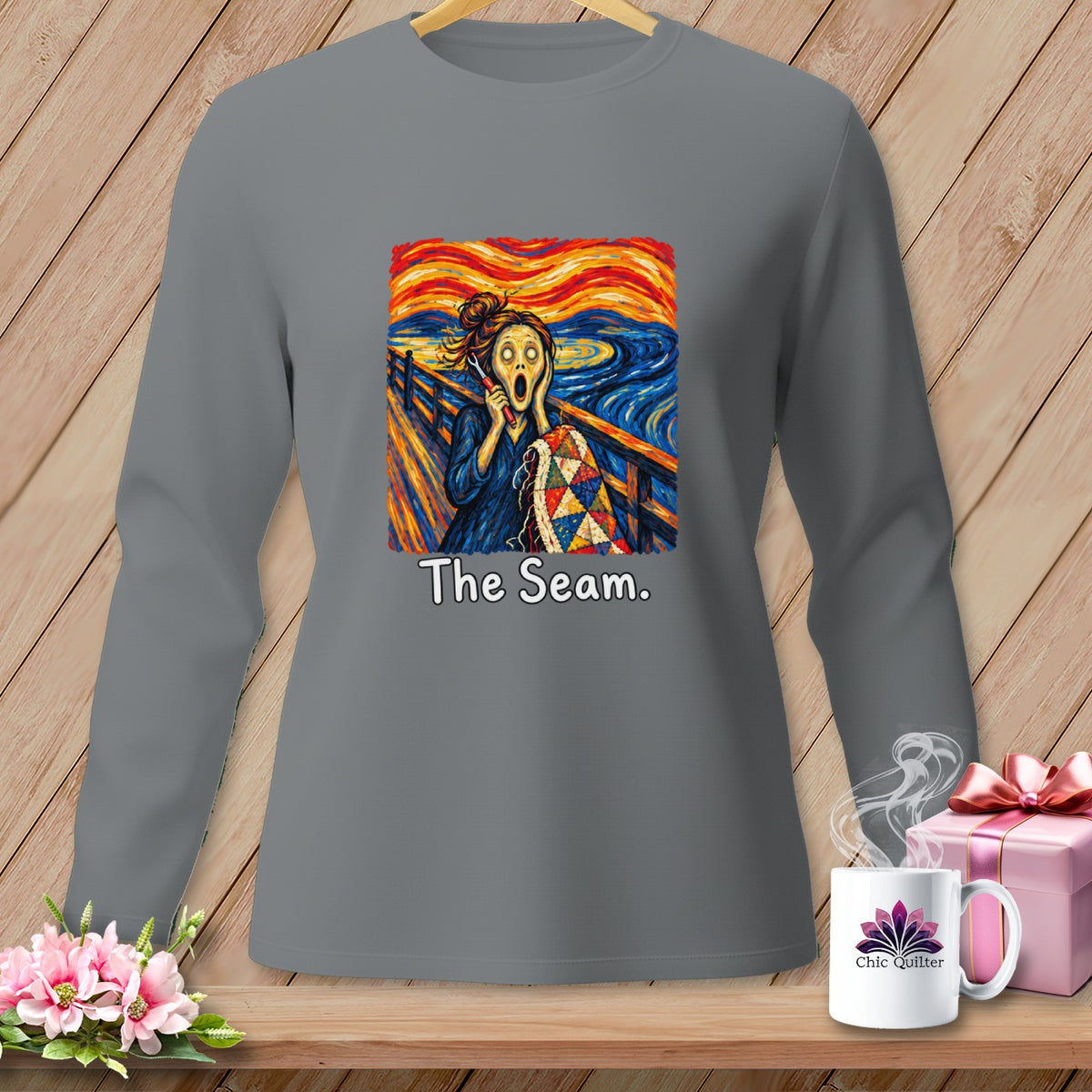 Gray long-sleeve shirt with Edvard Munch's "The Scream" adapted to hold a quilt, text "The Seam."